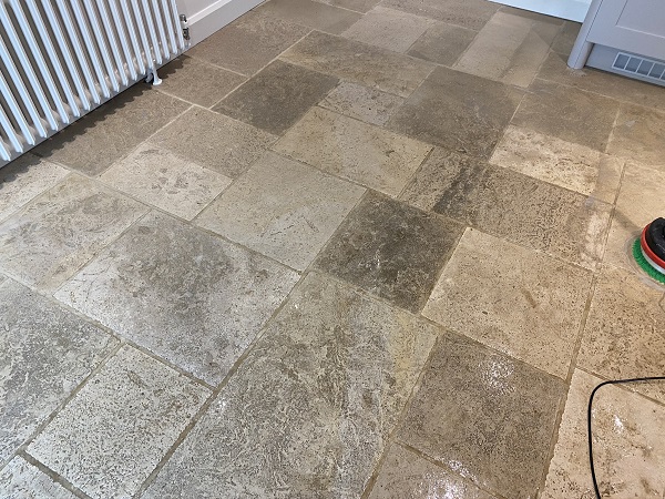 Limestone tiles and grout lines before cleaning